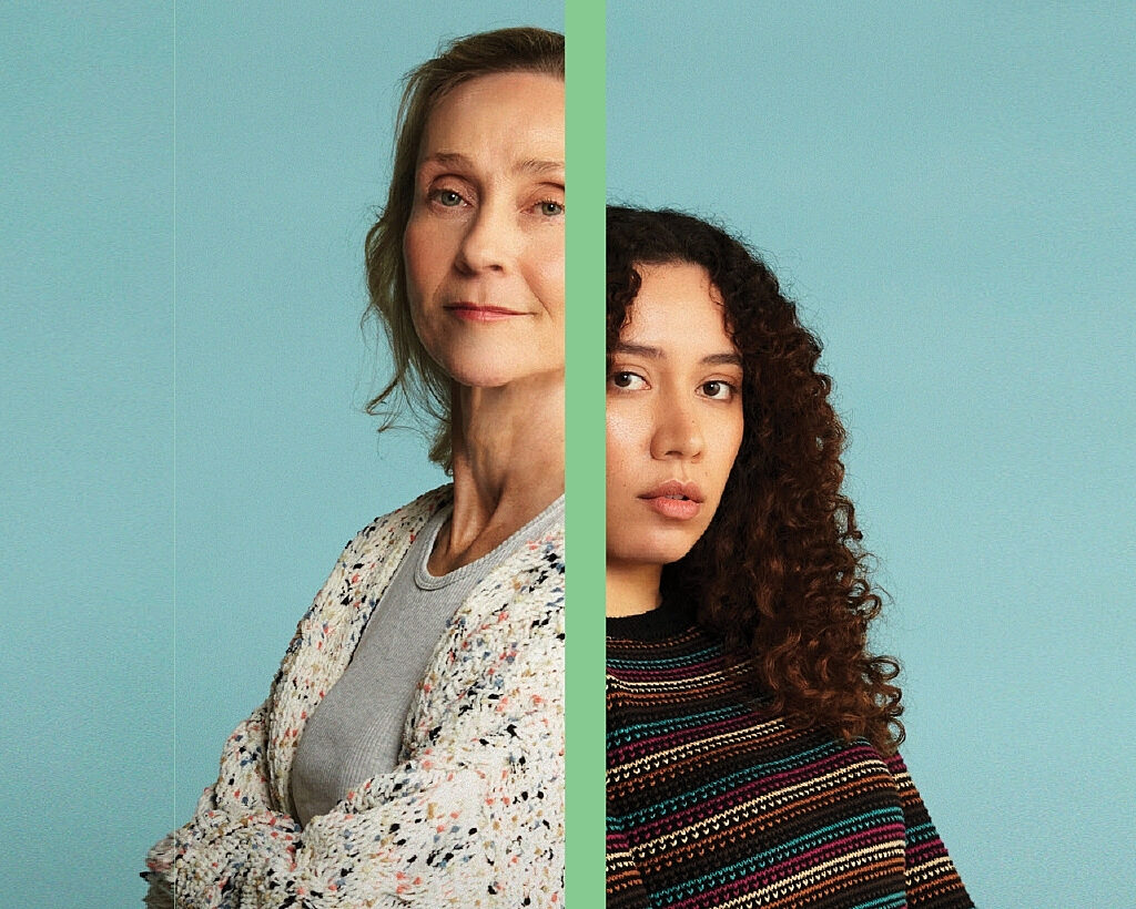 An older woman and a younger woman standing back to back with a divide between them.