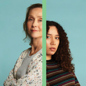 An older woman and a younger woman standing back to back with a divide between them.