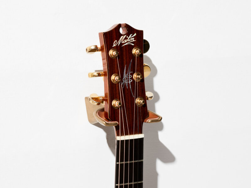 minim_sand-cast-hanger_brass-tan_with_Maton_Guitar