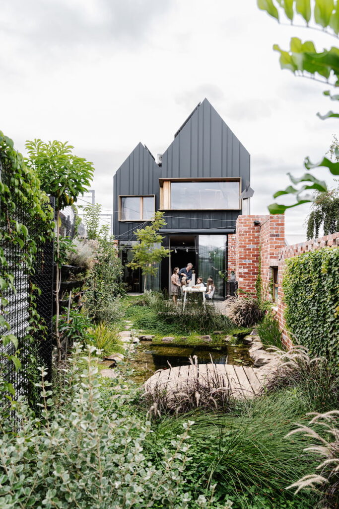 The lush garden uses a fish pond and an aquaponics system pumped through a vertical edible garden to share nutrients with fish and food | Melbourne Design Studio's Hutt 01 Passivhaus