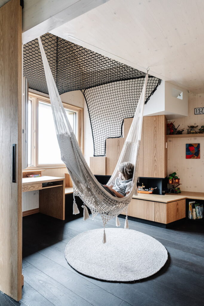 The small footprint is augmented by suspended nets and hammocks, creating literal hangout space within generous volumes | Melbourne Design Studio's Hutt 01 Passivhaus