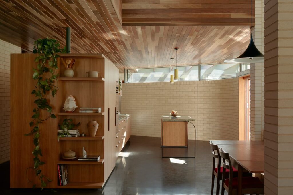With organic curves and robust materials, this kitchen takes inspiration from midcentury architecture. | Photography: Tom Ross