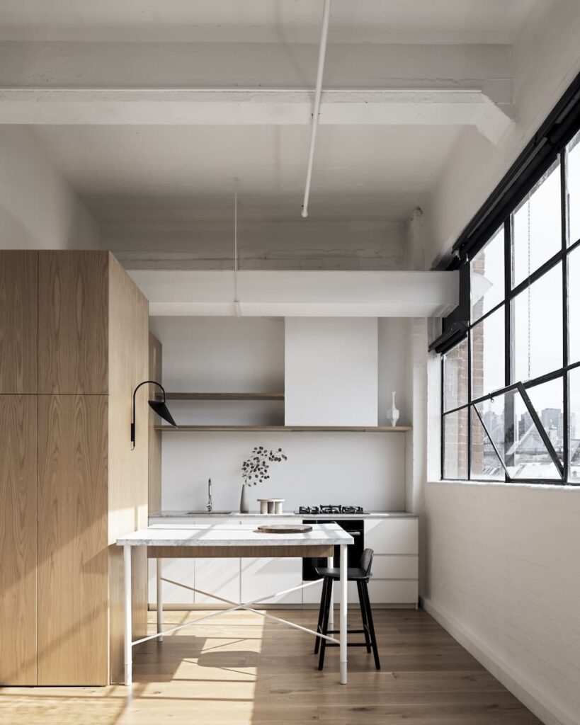Oak flooring and joinery, grey limestone benchtops and white surfaces create a relaxed, simple and clean aesthetic in this small kitchen. | Designed by Melanie Beynon | Photography: Tom Blachford