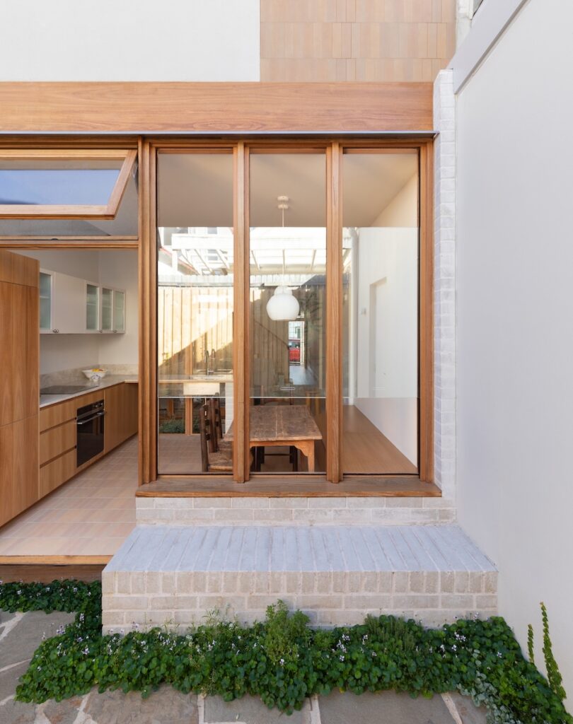Built-in brick seat connects rear façade of terrace house with courtyard, photographed for green magazine issue 105: Southern Calm by Joanne Ly.