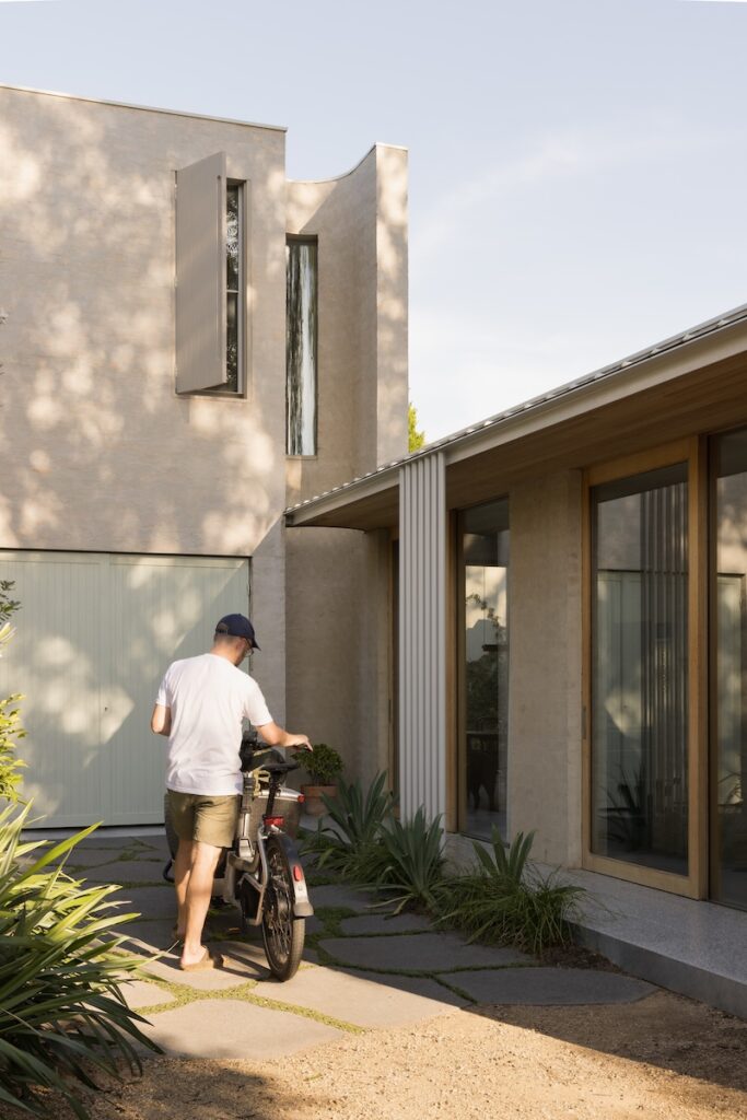 Rear façade opened to link multipurpose shed/gym with garden and rear laneway, photographed for green magazine issue 106: Playful Echoes by Timothy Kaye.