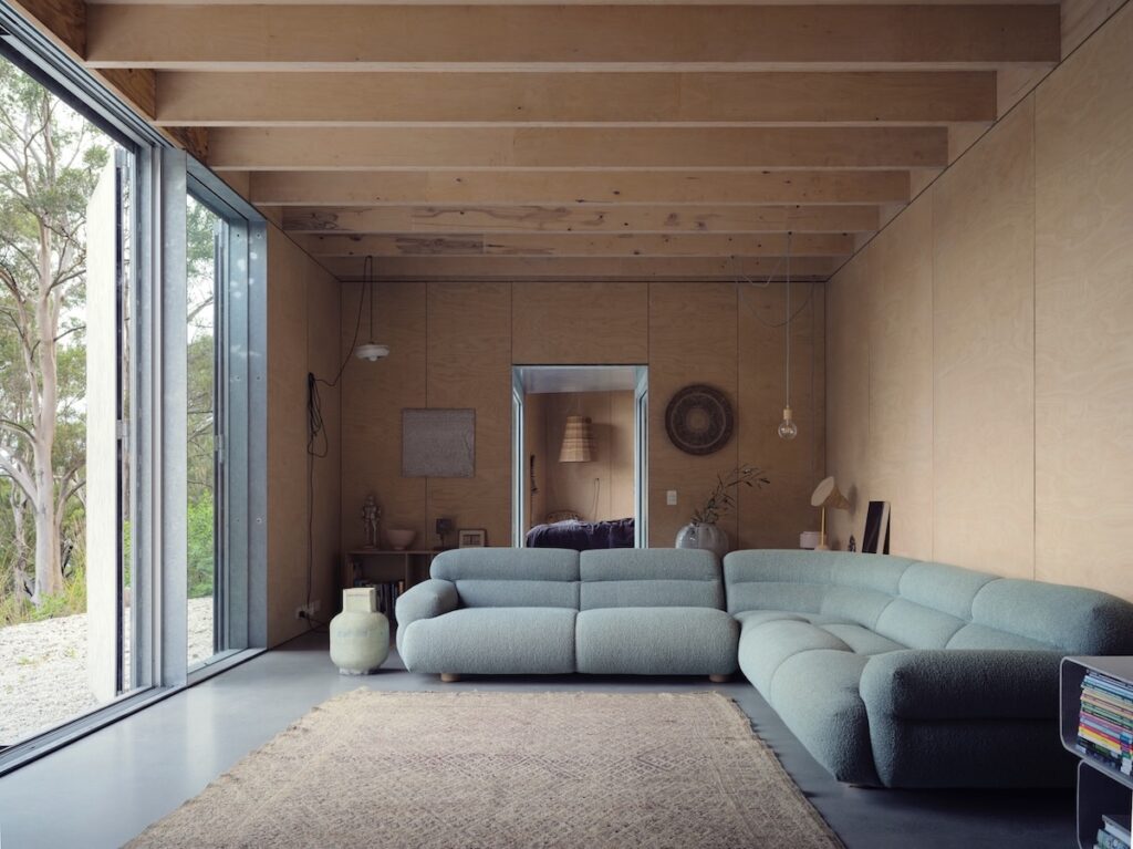 Hydronic concrete floor slab with full-height glazing into bushland, photographed for issue 106.