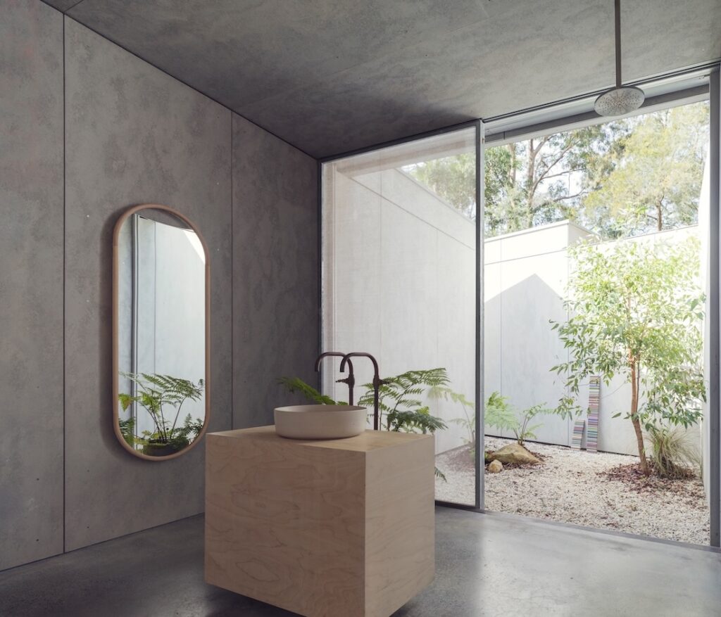 This bathroom opens directly onto a courtyard garden, photographed for issue 106: Flame Trees by Justin Alexander.