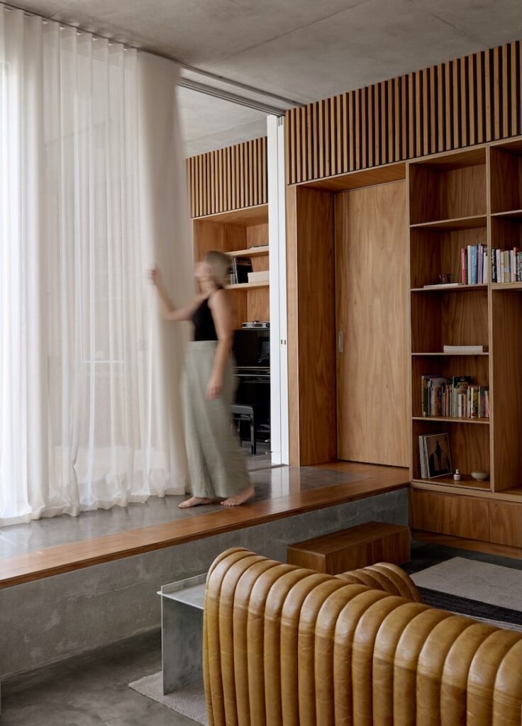 Interior living room showing curtains and timber-edged step-seat, photographed for issue 106: Snuck In by Jack Lovel.