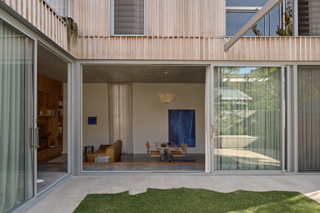 Outdoor living deck adjoining sunken living space with large openings, photographed for issue 106: Snuck In by Jack Lovel.