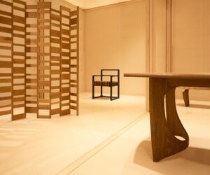 Detail view of the timber screen and seating within the Re-editions pavilion, highlighting American red oak construction and the geometric grid layout.