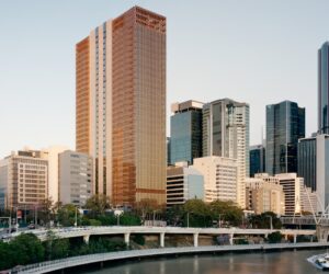 Wide view of the 205 North Quay tower within the Brisbane city skyline beside the river, surrounded by neighbouring commercial buildings.
