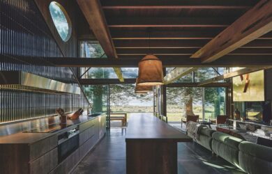 The kitchen forms the central zone, with a large island made from reclaimed teak acting as both bench and dining table, photographed for issue 107: Weather Withall by Zella Casey Brown.