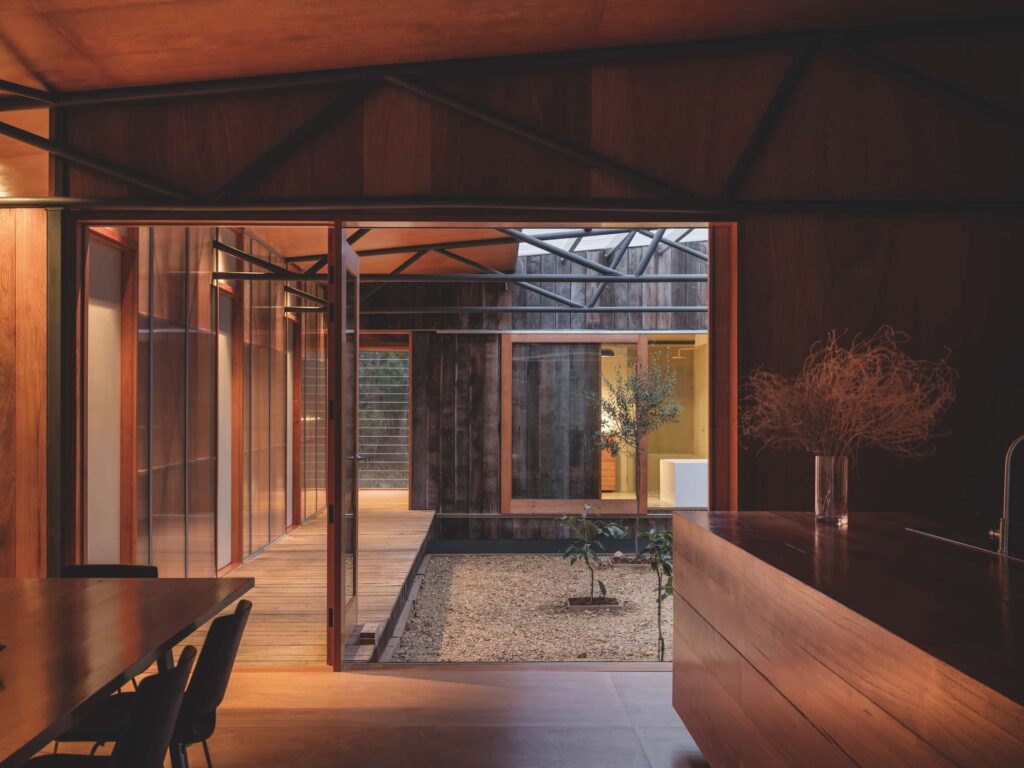The recycled steel trusses are exposed above the kitchen and internal courtyard, photographed for issue 107: Assemblage by Adam Gibson.