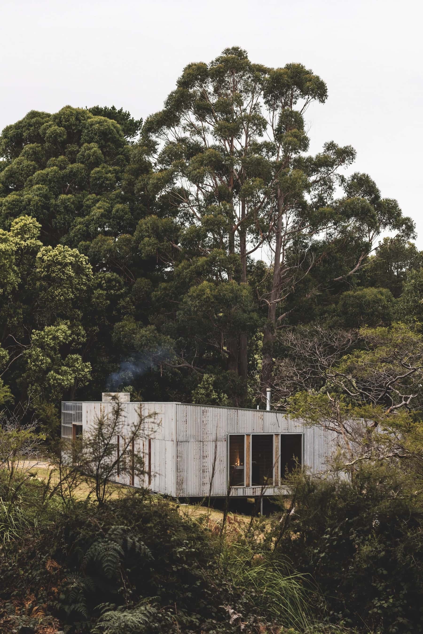 Louvred windows at the end of the indoor walkway and bathroom pull cooling bay breezes through the house, photographed for issue 107: Assemblage by Adam Gibson.