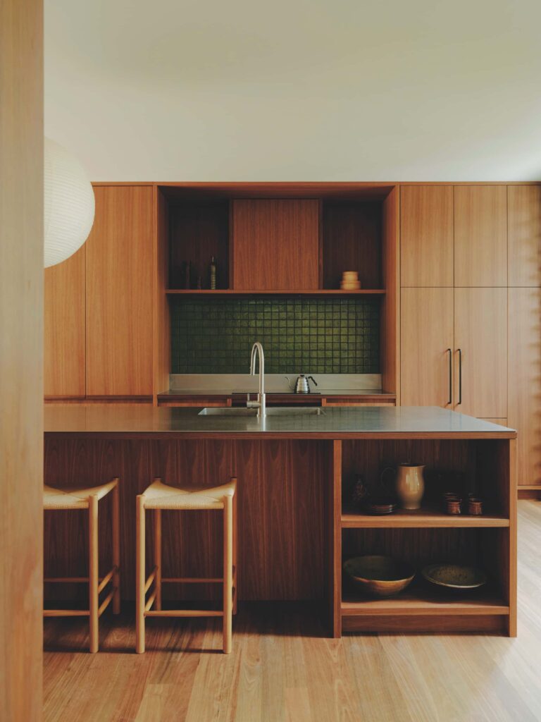 Spotted gum flooring, joinery and wall linings unify the kitchen in a warm, tactile palette that reinforces its calm, understated character, photographed for issue 107: A Coastal Compact by Tom Ross.
