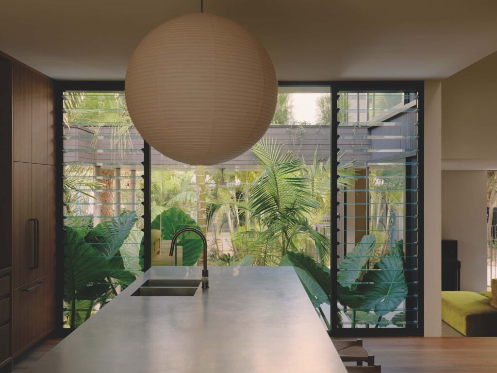 Sitting on a raised podium, the kitchen defines its own zone, flows seamlessly to the surrounding interiors and maintains a quiet dialogue with the streetscape, photographed for issue 107: A Coastal Compact by Tom Ross.