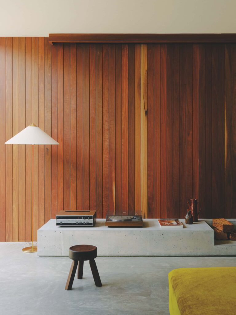 Sun-filled living spaces clad in spotted gum paired with carefully curated lighting creates a calm and moody atmosphere throughout the home, photographed for issue 107: A Coastal Compact by Tom Ross.