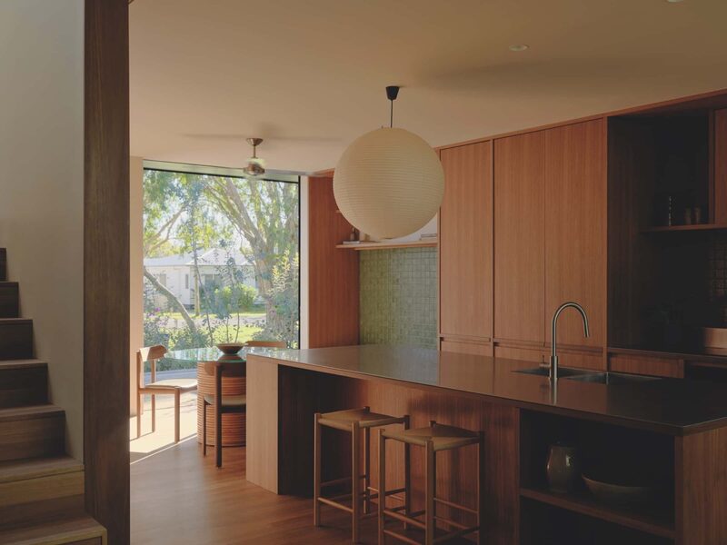Sitting on a raised podium, the kitchen defines its own zone, flows seamlessly to the surrounding interiors and maintains a quiet dialogue with the streetscape, photographed for issue 107: A Coastal Compact by Tom Ross.