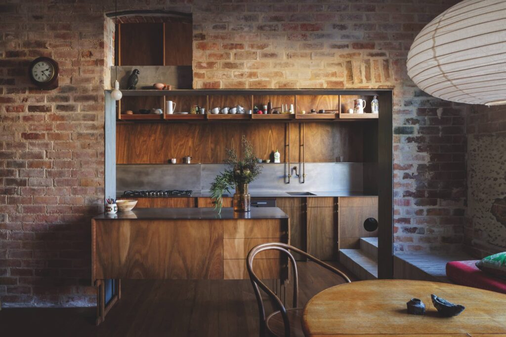 Minimal interior with conserved brickwork, spotted gum panelling and patinated brass at Fort House, photographed for issue 108: Out Look by Clinton Weaver.