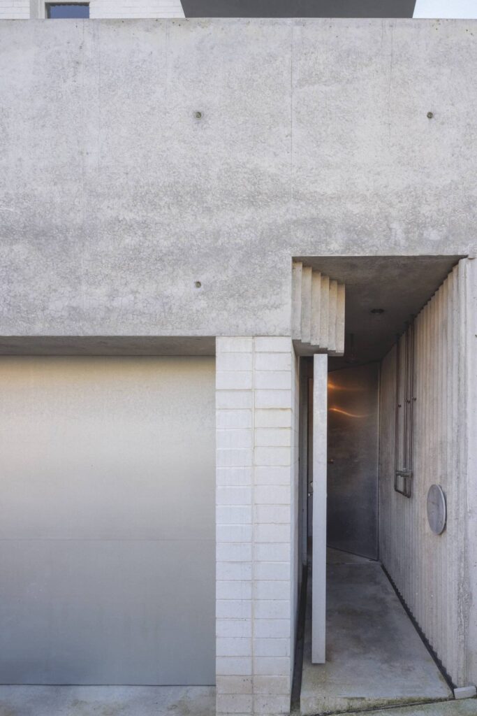Back door and outdoor shower with corrugated formed concrete wall at Fort House, photographed for issue 108: Out Look by Clinton Weaver.