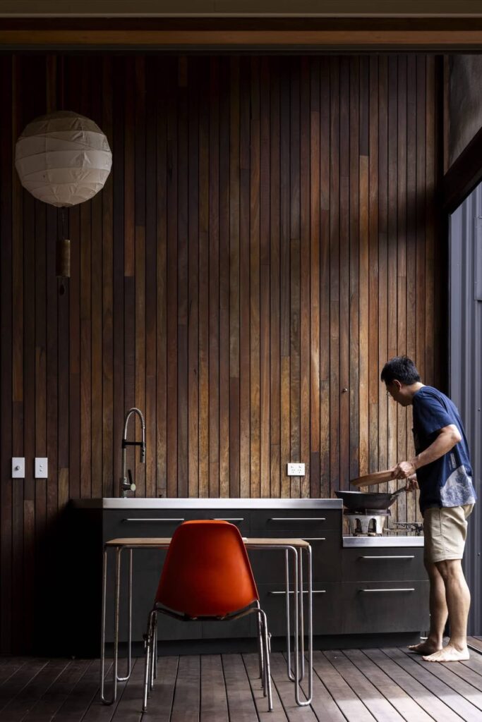 Covered outdoor deck kitchen with wok cooking area, photographed by Brett Boardman.