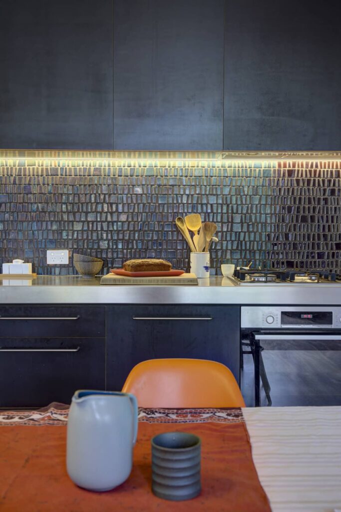 Kitchen splashback using leftover Venetian tiles at Cascading Effect, photographed by Brett Boardman.