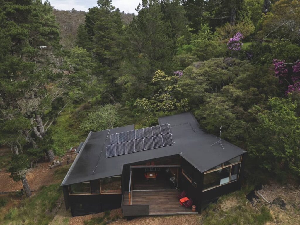 Elevated house positioned low on the slope with wind passing over the roof, photographed for issue 108: Cascading Effect by Brett Boardman.