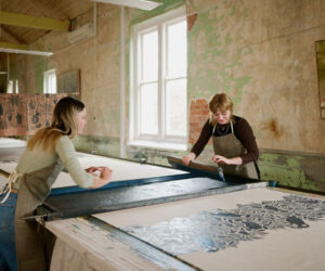 Artists creating large-scale textile prints inside the Ink & Spindle studio during Melbourne Design Week 2026.