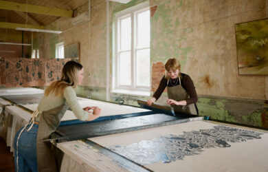 Artists creating large-scale textile prints inside the Ink & Spindle studio during Melbourne Design Week 2026.