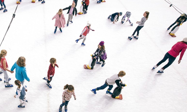 Aerial view of children skating on an ice rink