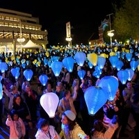 Crowd of people holding lanterns for the Leukaemia Foundations Light the Night event in the James Street Amphitheatre of the Perth Cultural Centre. 