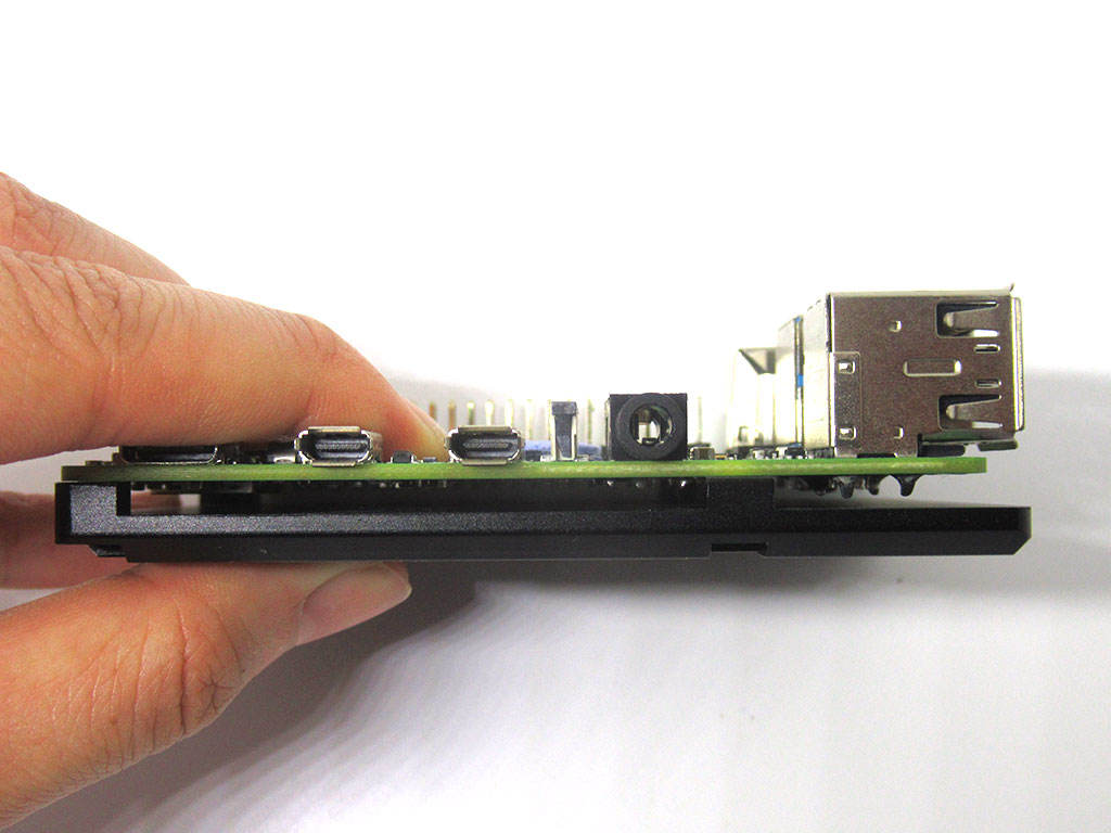 Place Raspberry Pi flat against bottom part of case