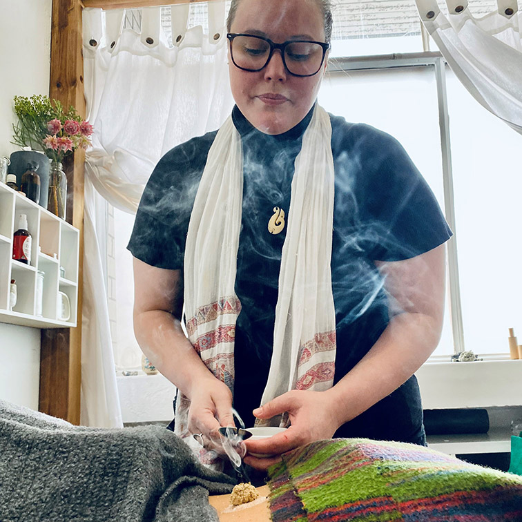 Female acupuncturist at work with patient and needles