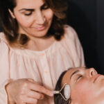 Female receiving beauty treamtent with face roller