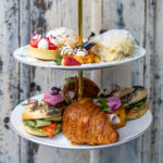 Cake display of small sweet treats and cakes