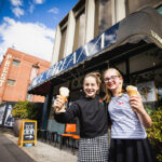 Two young female friends enjoying ice cream cones at Luther's Scoops on Sydney Road Brunswick