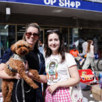 Friends posing with their puppy outside Melbourne Pet Rescue Superstore on Sydney Road Brunswick