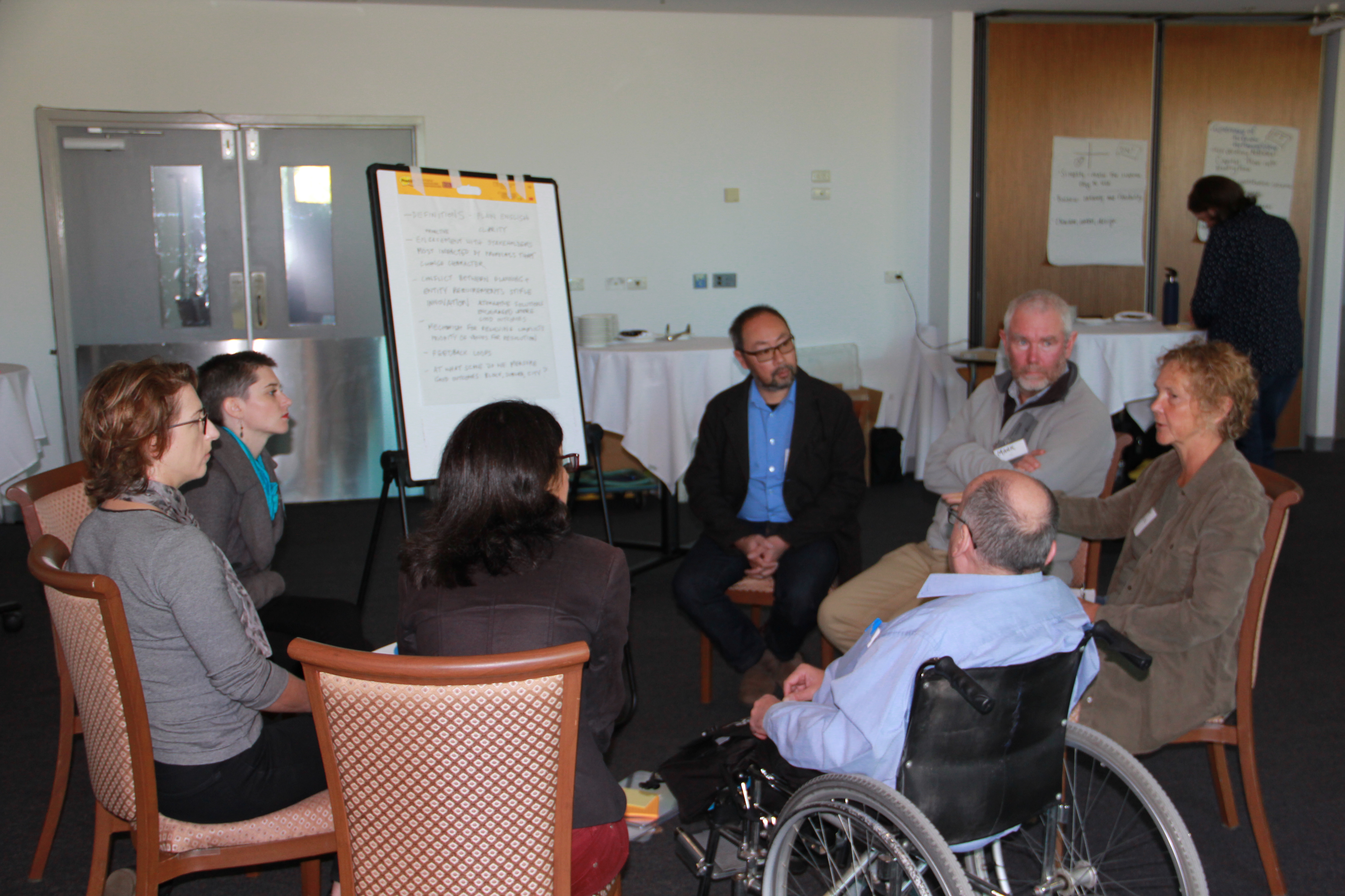 Image of people talking in a small group.