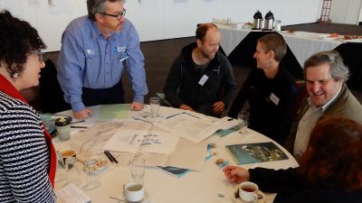 Image of participants discussing implementation