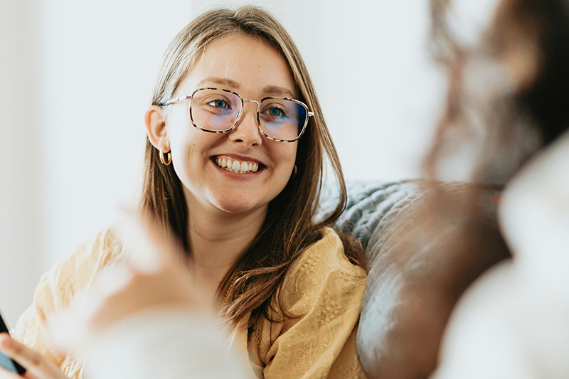 A psychology supervisor working with a client and smiling