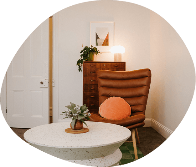 A therapy room featuring a brown armchair