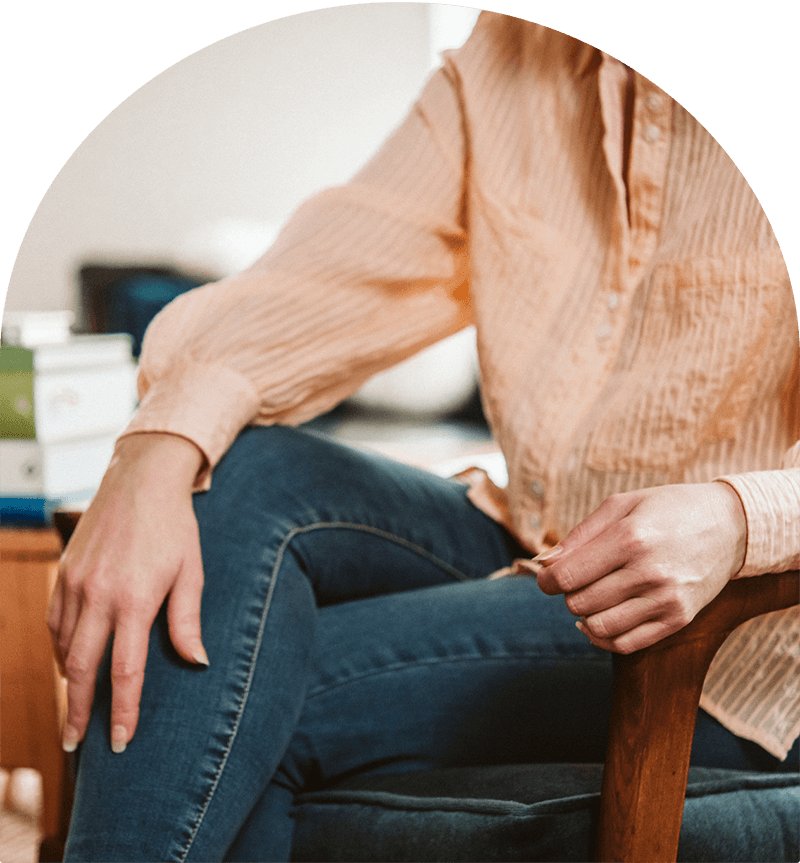 An autism psychologist sits cross-legged on a chair