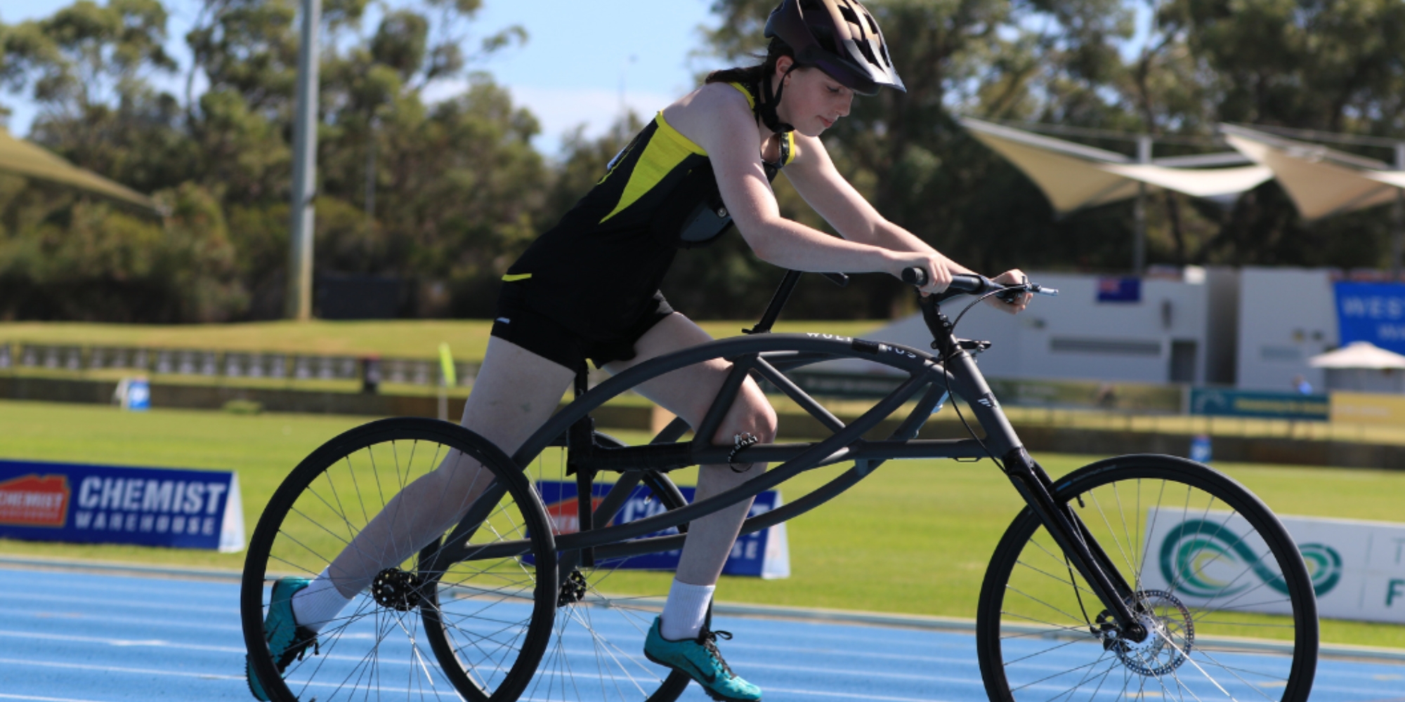 Frame running program for all abilities with Athletics West and Rebound WA banner. The banner consists of an image of a person on a FrameRunner trike/bike. They are wearing a helmet and sportswear