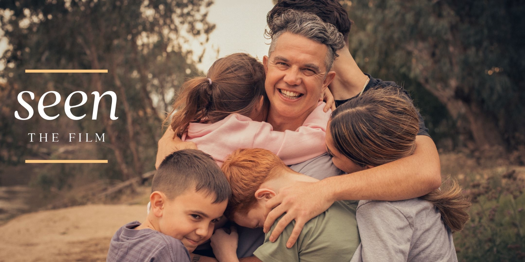 Seen screening with CliniKids banner. The banner consists of an image of the documentary's promotional image and consists of an imge of a father and his five children hugging him. He's smiling at the camera and they are all outside with the Australian bushland around them