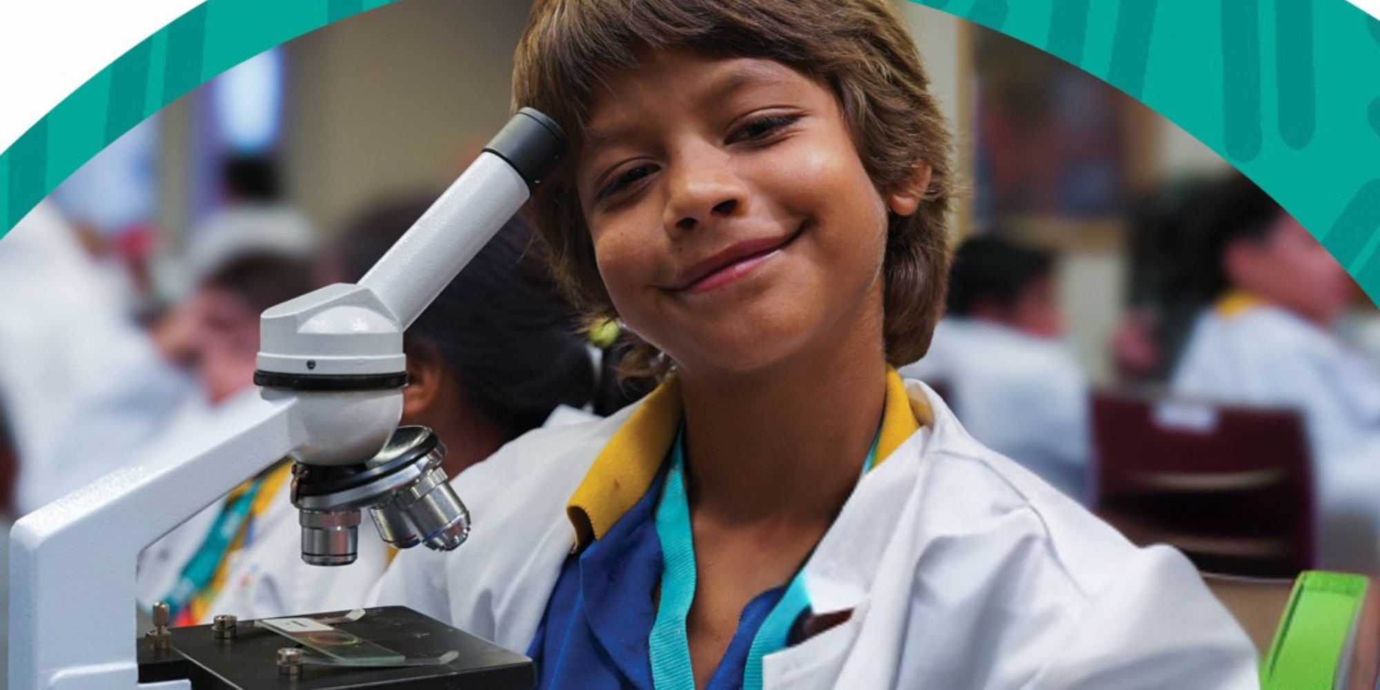 STEM Festival in Kalgoorlie with The Kids Research Institute Australia banner. The banner consists of the STEM Festival logo and a picture of a boy wearing a lab coat with a microscope beside him. He is smiling at the camera