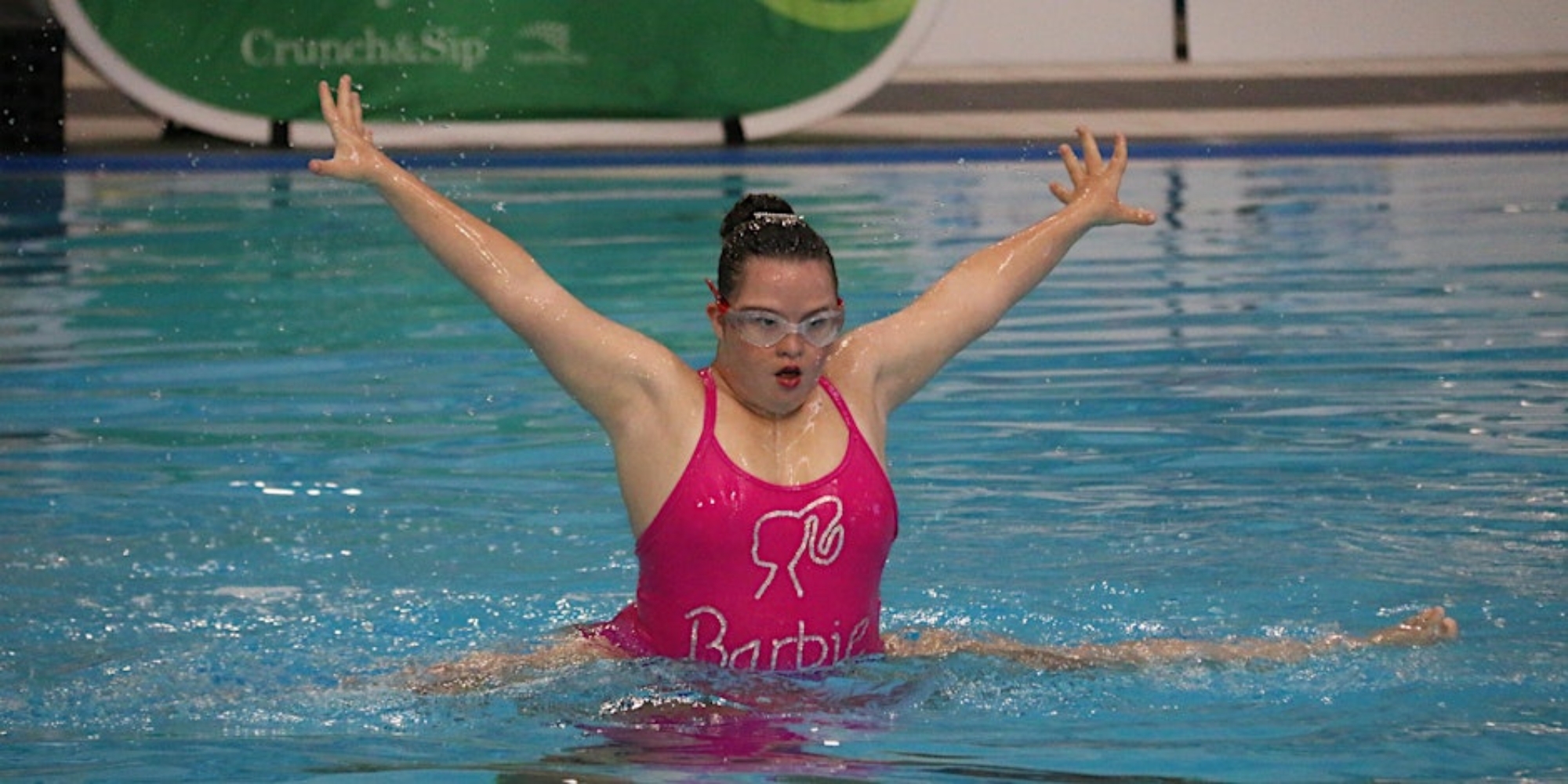Come and try artistic swimming with Artistic Swimming WA banner. The banner consists of an image of a young woman performing a dance move with her arms up and out in a pool.
