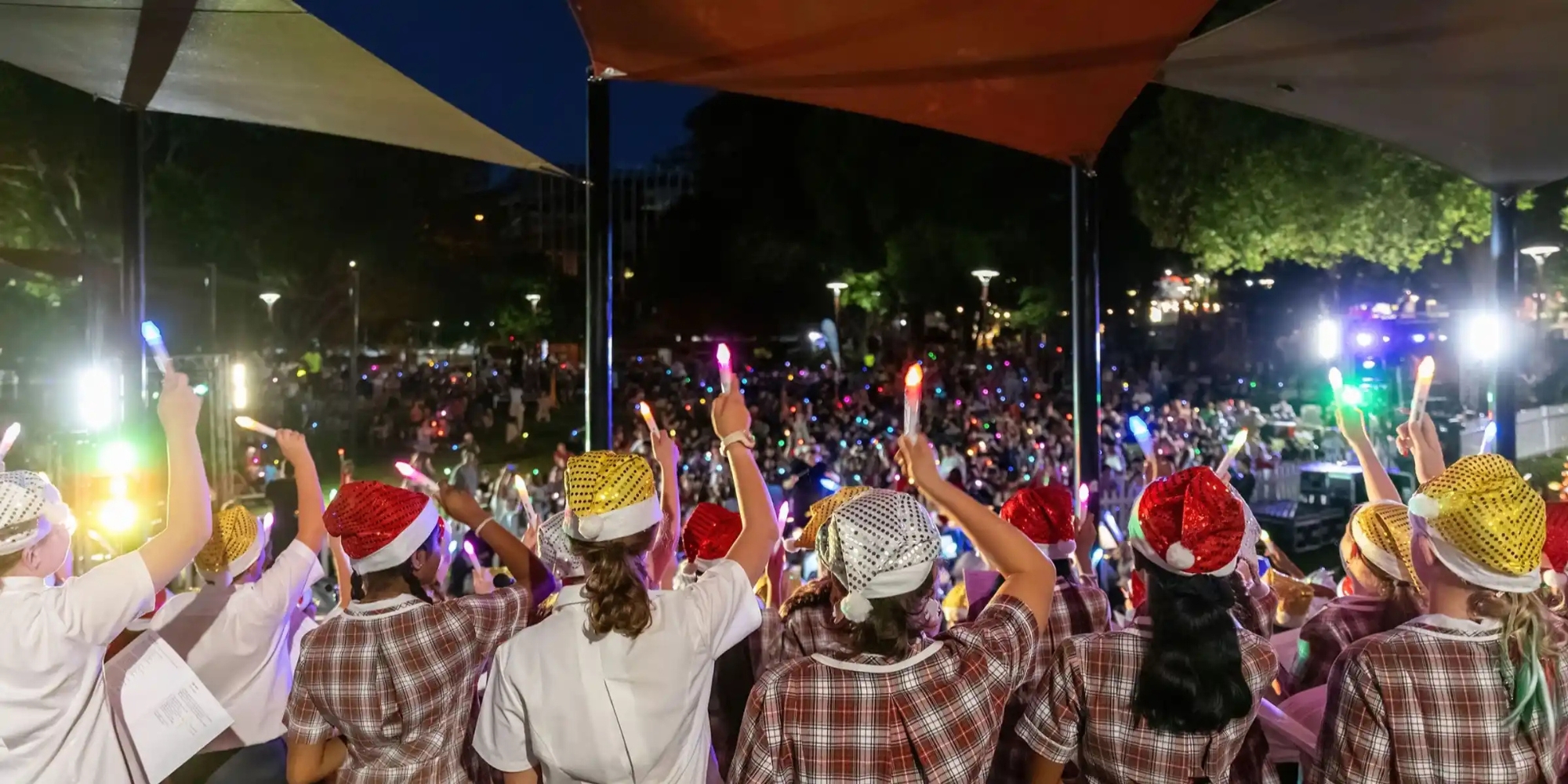 Accessible Carols by Candlelight with the City of Armadale and DADAA banner. The banner consists of an image of people at a concert holding up LED candles wearing santa hats.
