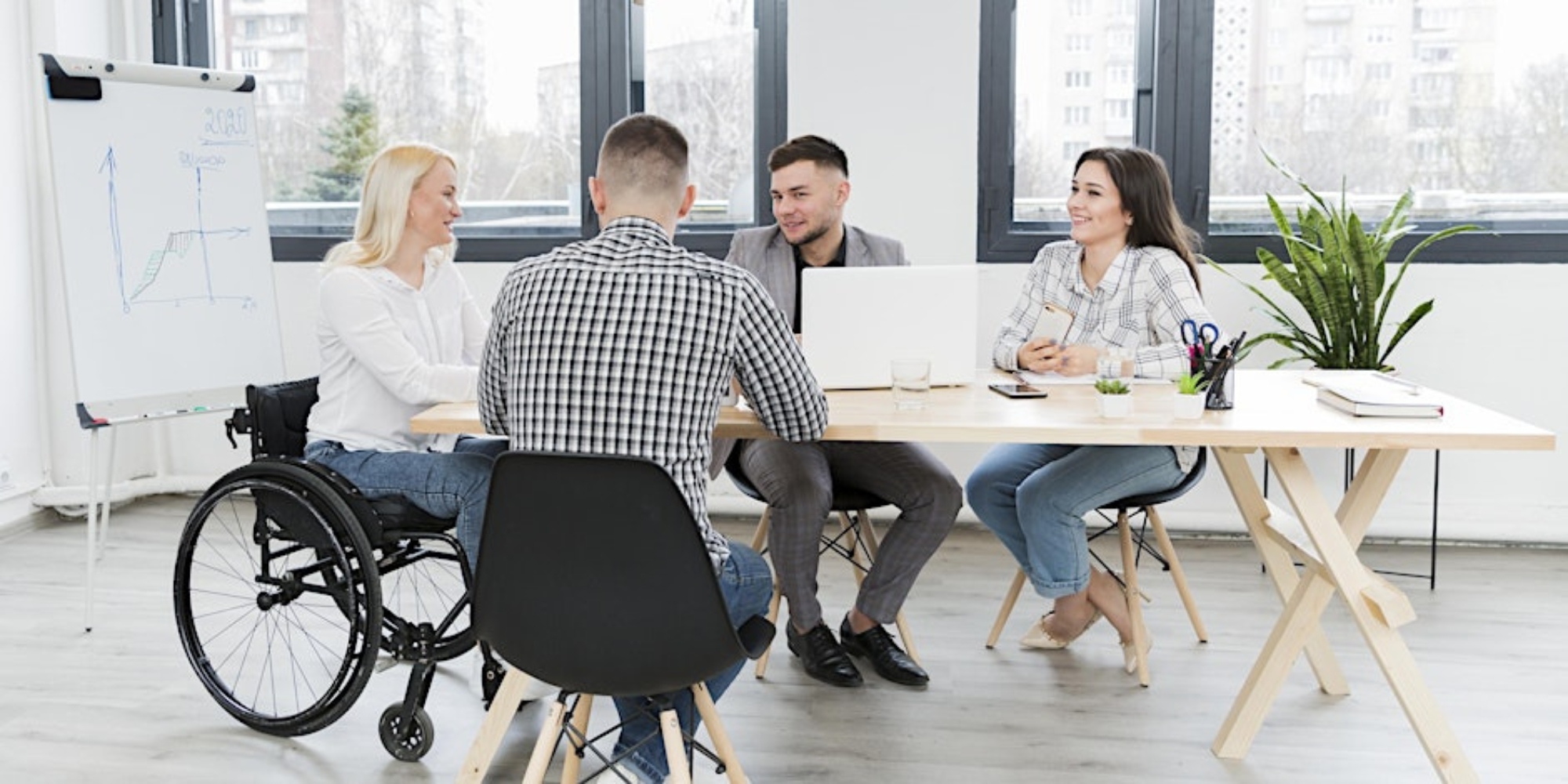 Employment Essentials: A Job Ready Workshop with the City of Canning banner. The banner consists of an image of a group of adults sitting at a desk at the office in a meeting room. One person is sitting in a wheelchair and the rest are sitting on chairs.