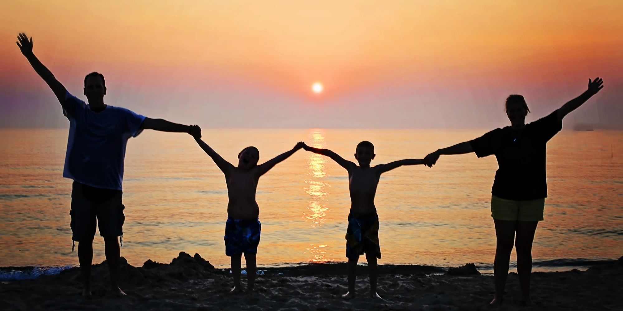 WA Foundation for Deaf Children (WAFDC) Family Camp banner. The banner consists of an image of a families shadow while they are holding hands at the beach at sunset.
