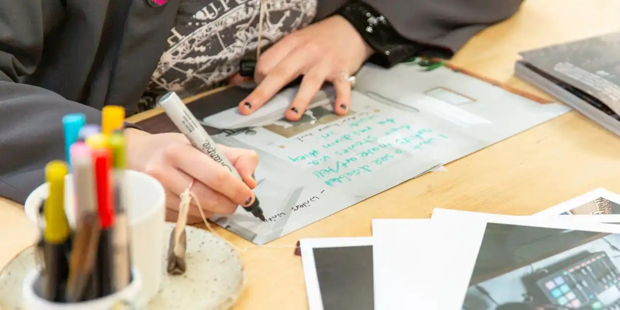 Chronically Crafty sessions with the City of Stirling banner. The banner consists of an image of a young person at a desk with a room up on the art work or text their working on. They are using a black pen to write and these are coloured pens in the forefront.
